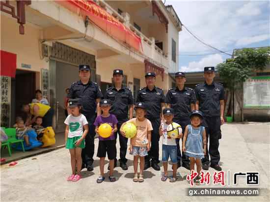 图为民警与结对帮扶的留守儿童合影。李欣蓉摄 崇左领土警方开展“关爱留守儿童、共筑平安领土”主题勾当