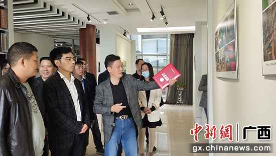 图为与会高朋旅行摄影展。 桂林市临桂区举行脱贫攻坚摄影展